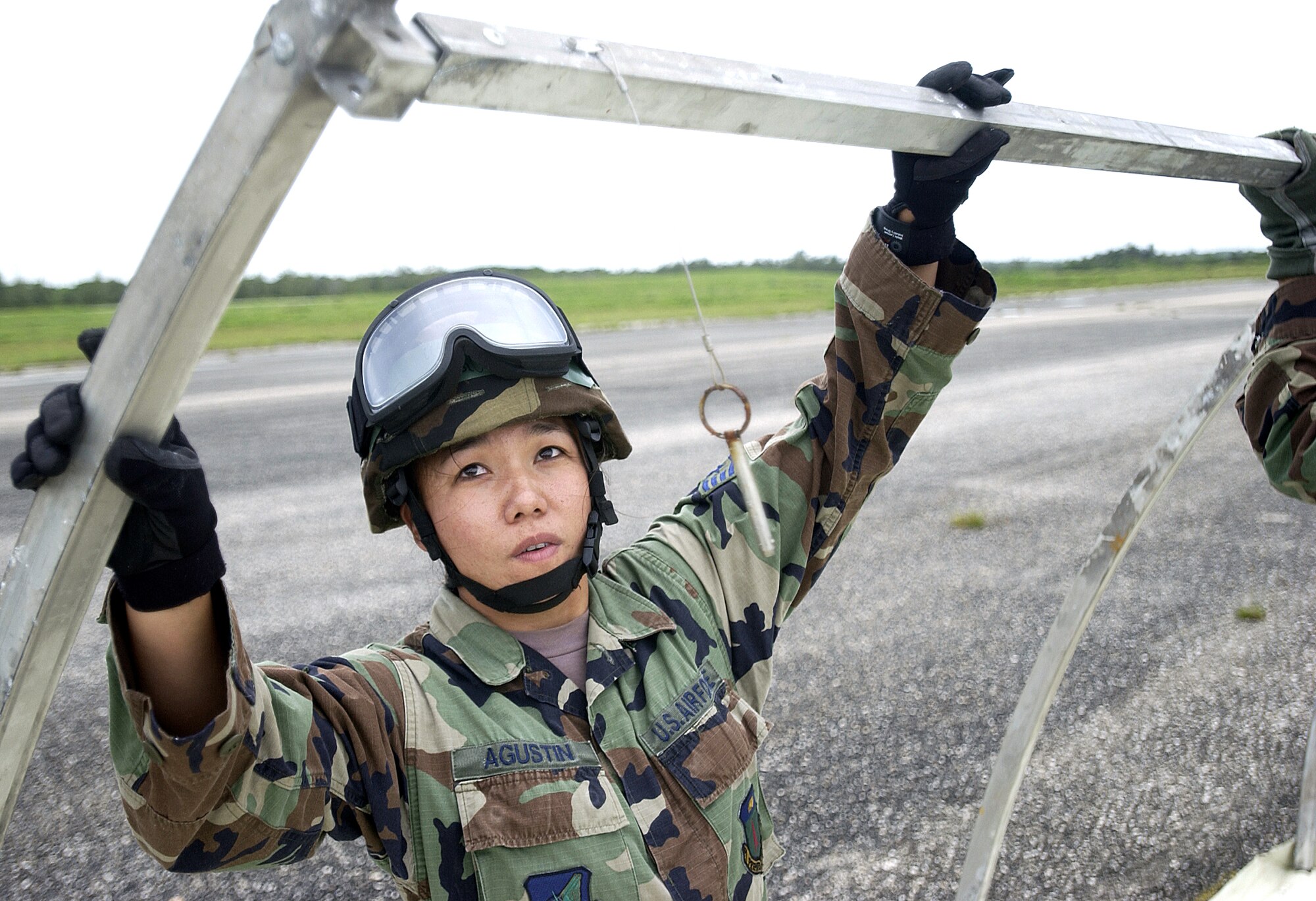 ANDERSEN AIR FORCE BASE, Guam -- Staff Sgt Delina Agustin sets up a tent here during Exercise Beverly Palm 05-07.  The routine exercise is held several times a year to sharpen the mobility and wartime capabilities of participating servicemembers.  Sergeant Agustin is assigned to the 613th Mobility Response Squadron.  (U.S. Air Force photo by Airman Michael S. Dorus)
(U.S. Air Force photo by Airman Michael S. Dorus)
(RELEASED)

