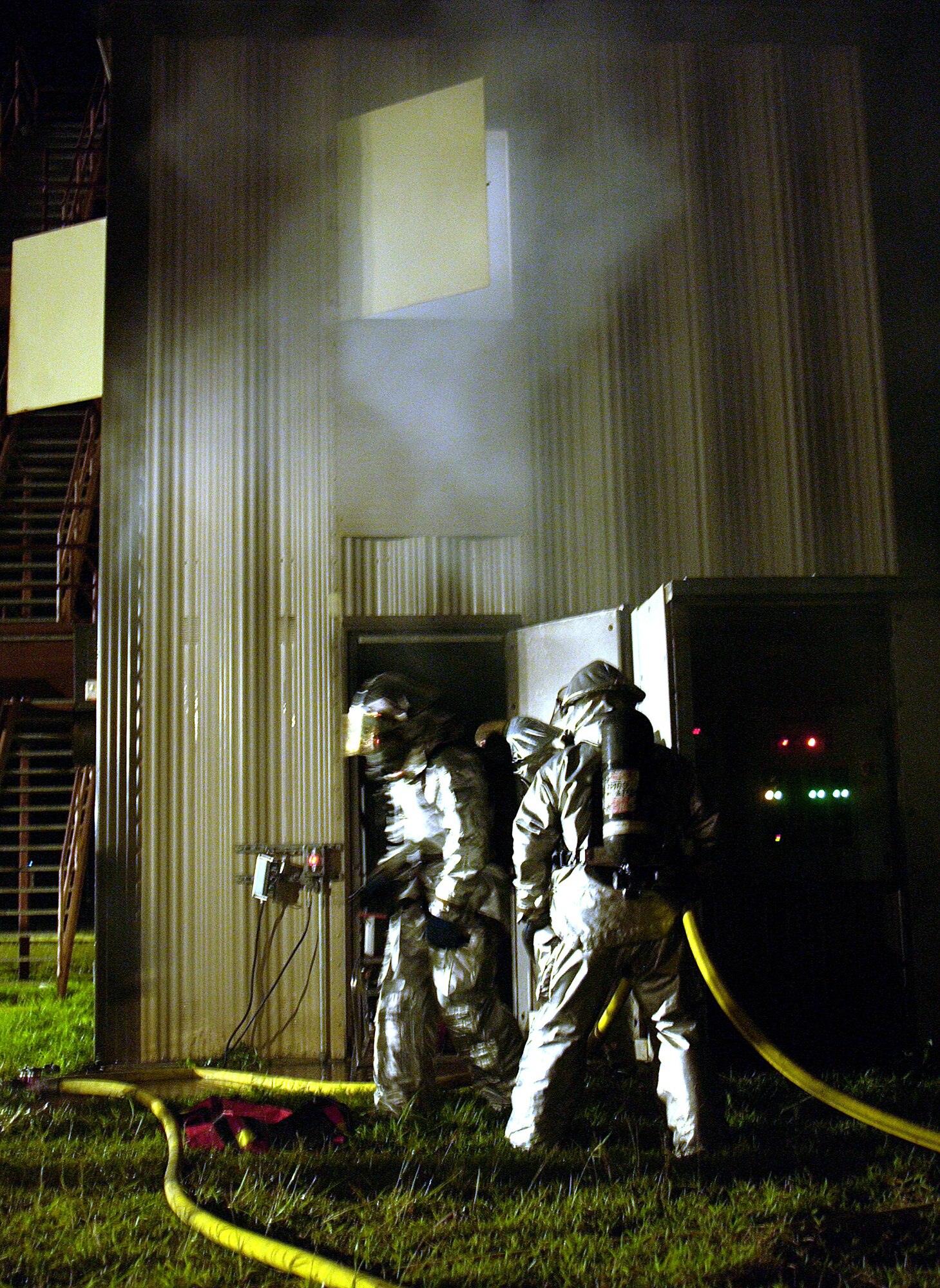 ANDERSEN AIR FORCE BASE, Guam -- Firefighters with the 36th Civil Engineer Squadron respond to a live fire on the fire training grounds here during Exercise Beverly Palm 05-07.  The routine exercise is held several times a year to sharpen the mobility and wartime capabilities of participating servicemembers.  (U.S. Air Force photo by Airman 1st Class Miranda Moorer)