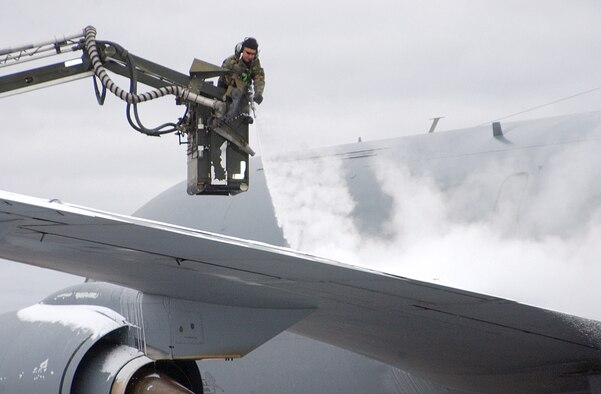 EIELSON AIR FORCE BASE, Alaska -- An Airman de-ices a KC-135 Stratotanker from Kadena Air Base, Japan, before it takes off on its first Cope Thunder mission Oct. 10.  The two-week Alaskan exercise is the largest air combat training exercise, involving more than 1,000 active-duty and Air National Guard Airmen and 87 aircraft.  (U.S. Air Force photo by Staff Sgt. A.C. Eggman)