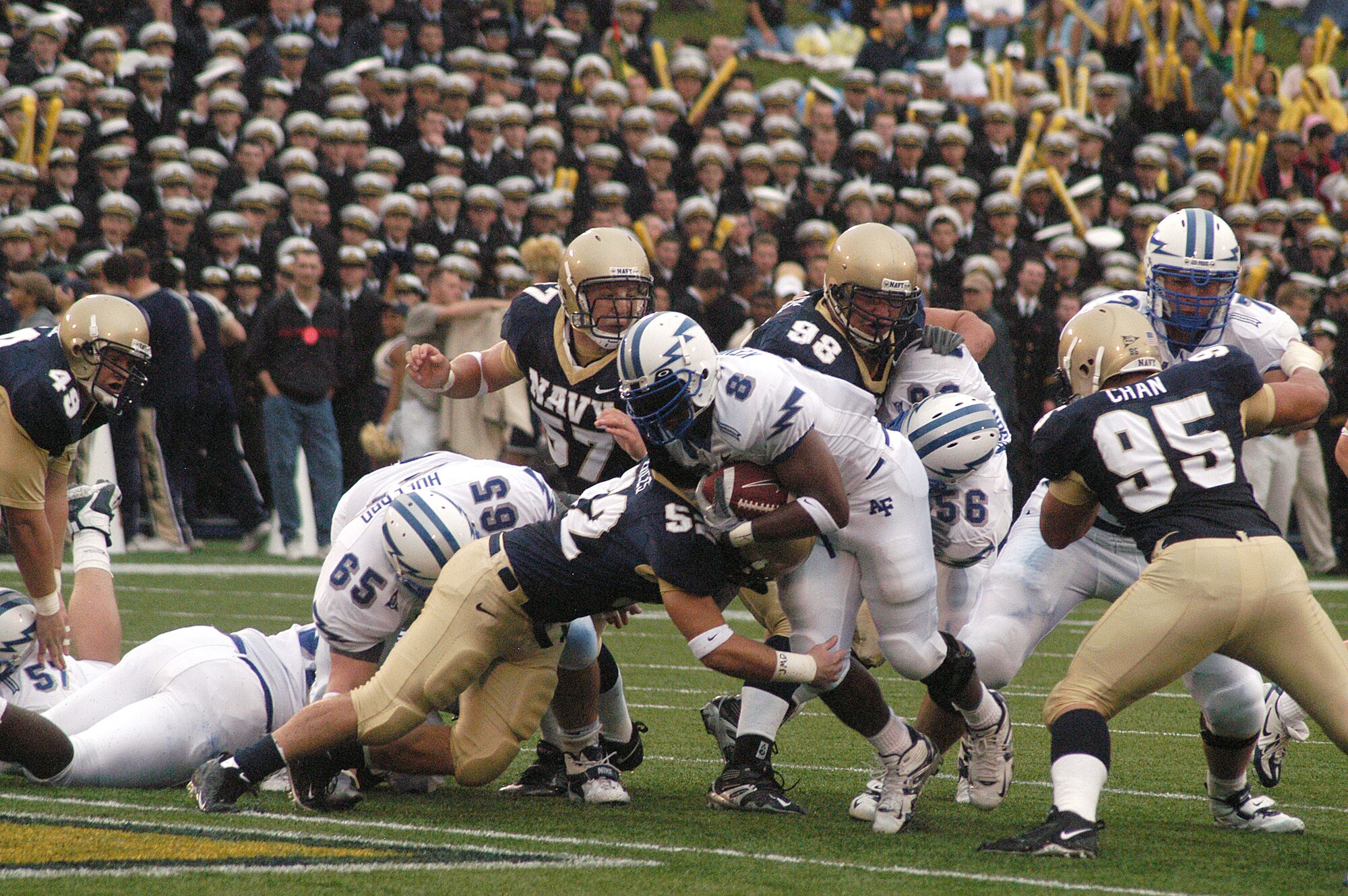 ANNAPOLIS, Md. -- Falcon fullback Jacobe Kendrick pushes his way forward for extra yardage after being wrapped up by Navy linebacker Jake Biles. Navy defeated Air Force 27-24. (U.S. Air Force photo by Tech. Sgt. Roy Utley)