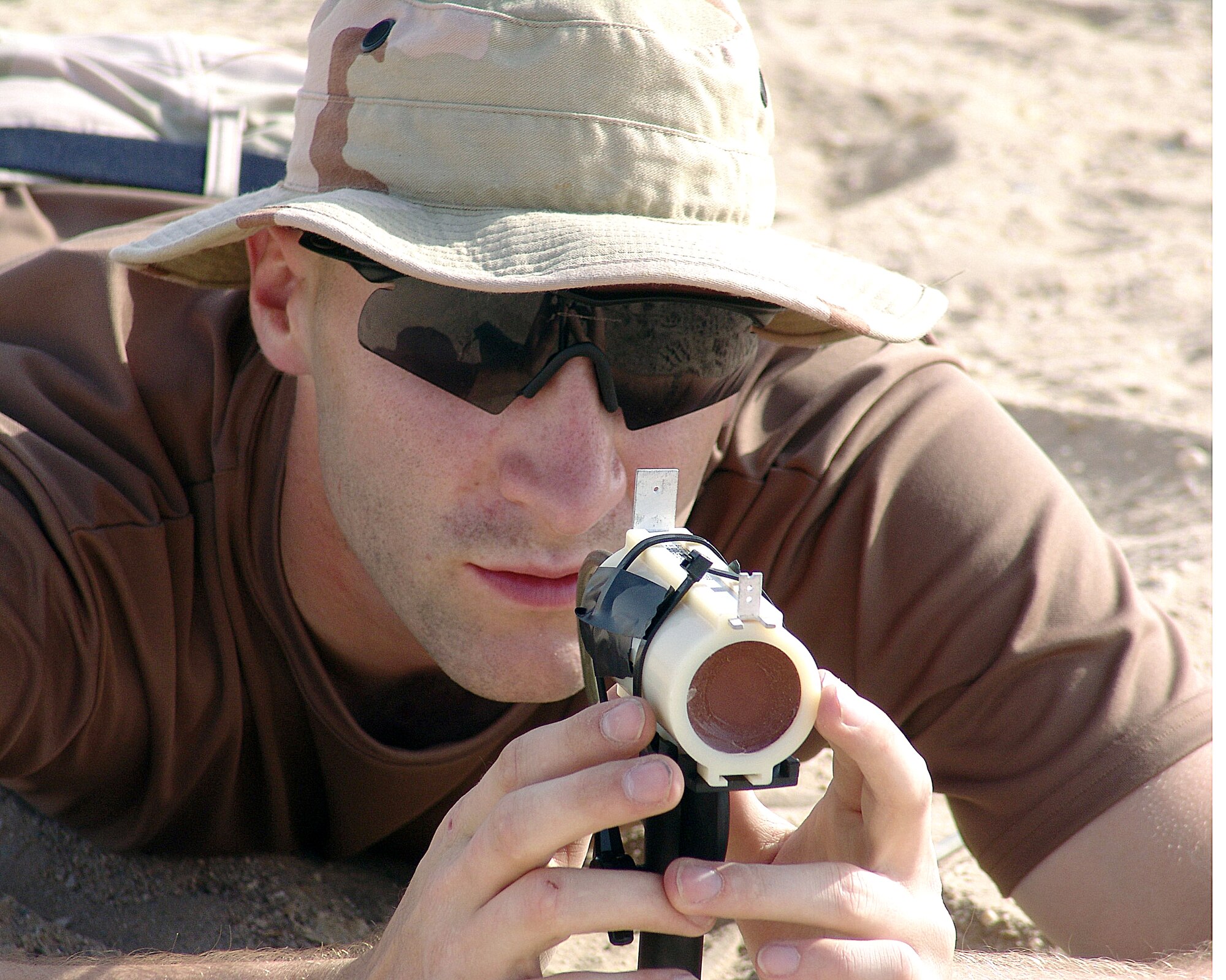 SOUTHWEST ASIA -- Senior Airman Gordon Hohman sights in a mark to see the impact that it has with certain materials.  He is assigned to the 386th Expeditionary Civil Engineer Squadron's explosive ordnance disposal unit. (U.S. Air Force photo by Senior Airman Michael A. Garza)