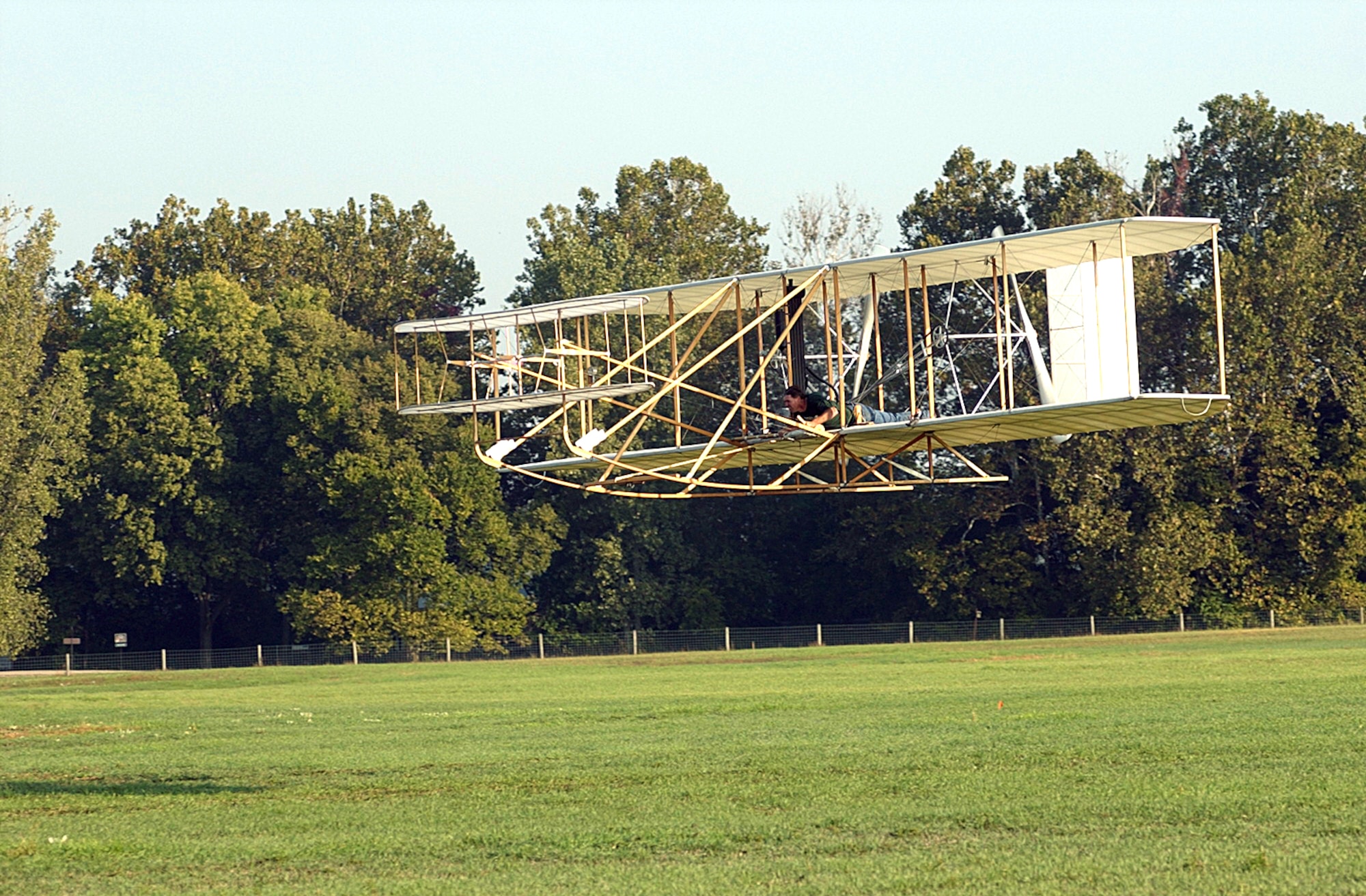 WRIGHT-PATTERSON AIR FORCE BASE, Ohio -- Mark Dusenberry flies over Huffman Prairie during the Centennial of Practical Flight ceremony Oct. 5. Orville and Wilbur Wright used the field to research and develop their aircraft, and flew over the same location 100 years earlier to the day. Mr. Dusenberry is the pilot and creator of the world's only exact replica of the 1905 Wright Flyer. (U.S. Air Force photo)