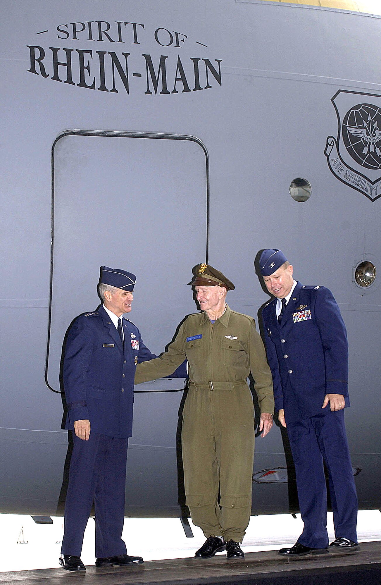 RHEIN-MAIN AIR BASE, Germany - (From left) Lt. Gen. Christopher A. Kelley, Air Mobility Command vice commander; retired Lt. Col. Gail Halvorsen; and Col. Bradley Denison, 469th Air Base Group commander, unveil the newly named C-17 Globemaster III "Spirit of Rhein-Main" during the base closure ceremony here Oct. 10. The ceremony officially marked an end of 60 years of airlift history. Flying at the base ended Sept. 30 and the "Gateway to Europe" will transition to Ramstein and Spangdahlem Air Bases in Germany. (U.S. Air Force photo by Staff Sgt. Marie Cassetty)