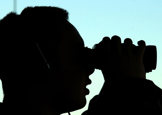 EIELSON AIR FORCE BASE, Alaska -- Airman 1st Class Kim examines aircraft here on Oct. 7 from the tower before the start of exercise Cope Thunder 06-1.  The two-week Alaskan exercise is the largest air combat training exercise, involving more than 1,000 active-duty and Air National Guard Airmen and 87 aircraft.  Airman Kim is assigned to the 354th Operations Group.  (U.S. Air Force photo by Staff Sgt. Joshua Strang)