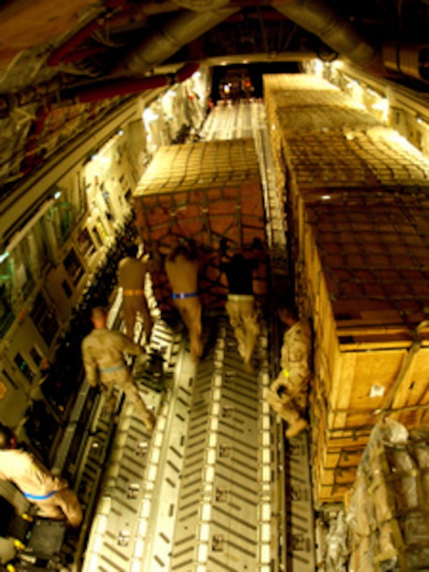 U.S. Air Force airmen unload cargo in Islamabad, Pakistan, on Oct. 11, 2005. The Department of Defense is supporting the U.S. Agency for International Development by providing disaster relief supplies and services following the massive earthquake that struck Pakistan and parts of India and Afghanistan. 