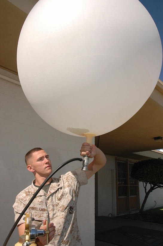 Lance Cpl. Darien Garland, Marine Wing Support Squadron 371 weather observer and native of Albany, N.Y., fills a sonde, or weather balloon, with helium outside Station Meteorological Oceanographic Command Oct. 11. Station METOC doesn?t send up sondes often, and when they do, it is mostly for training purposes, but Marines keep in practice in case of deployment. The sonde collects information such as wind speed, direction, temperature and humidity at different heights and sends the information back to the Marines in order for them to more accurately forecast the weather.