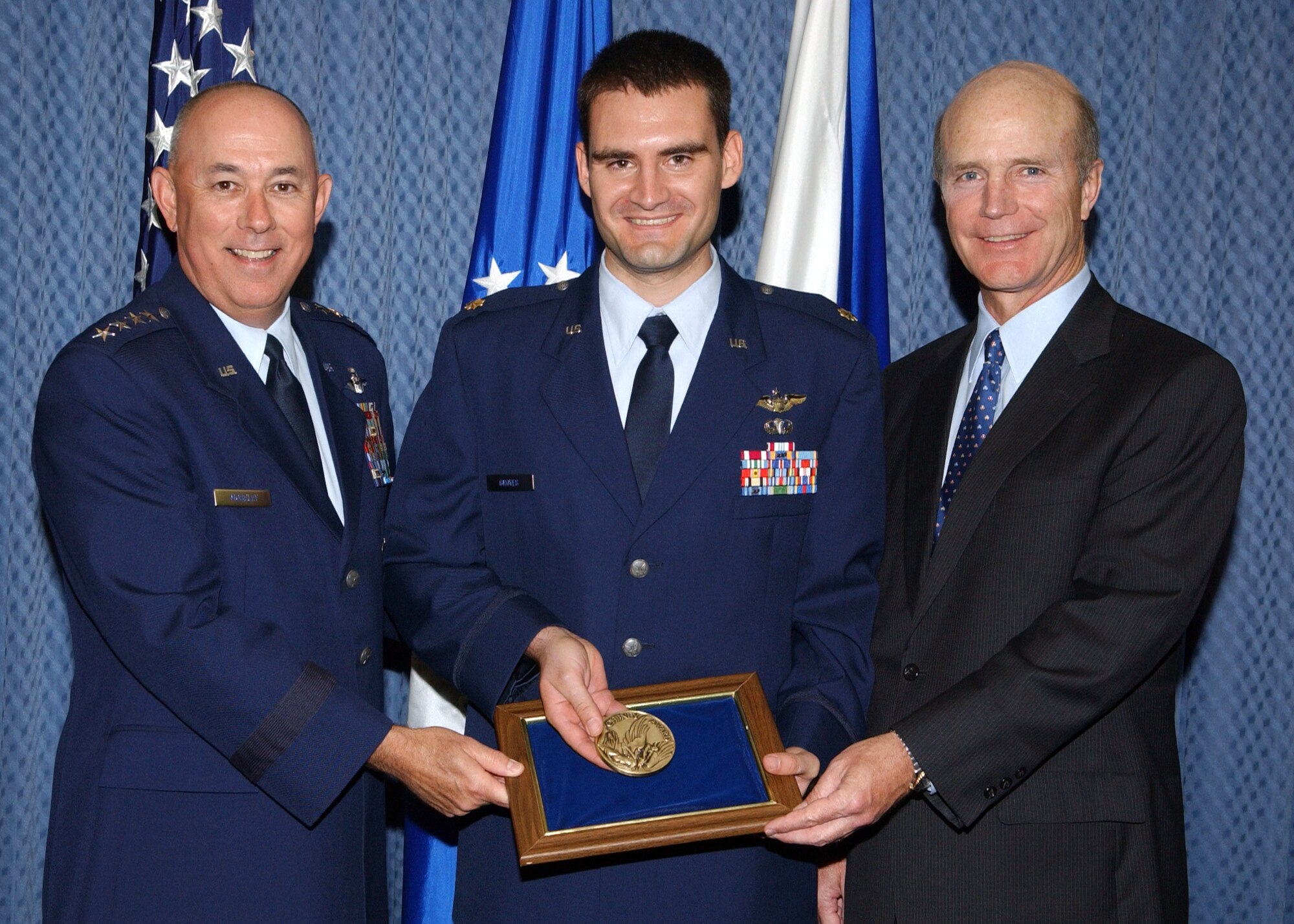 WASHINGTON -- Maj. John Groves receives the Cheney Award from Acting Secretary of The Air Force Pete Geren and Chief of Staff of the Air Force T. Michael Moseley. (U.S. Air Force photo by Larry McTighe)                          