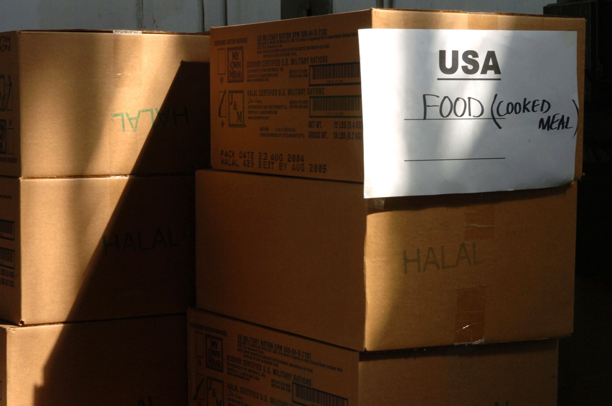 CHAKLALA, Pakistan -- Boxes of emergency rations donated by the United States are stacked in a hanger at Pakistani air force base here Oct. 12, awaiting transportation by helicopter to remote villages in the region. The Department of Defense is participating in the multinational effort to provide humanitarian assistance and support to Pakistan and parts of India and Afghanistan following a devastating earthquake. (U.S. Navy photo by Petty Officer 2nd Class Timothy Smith) 