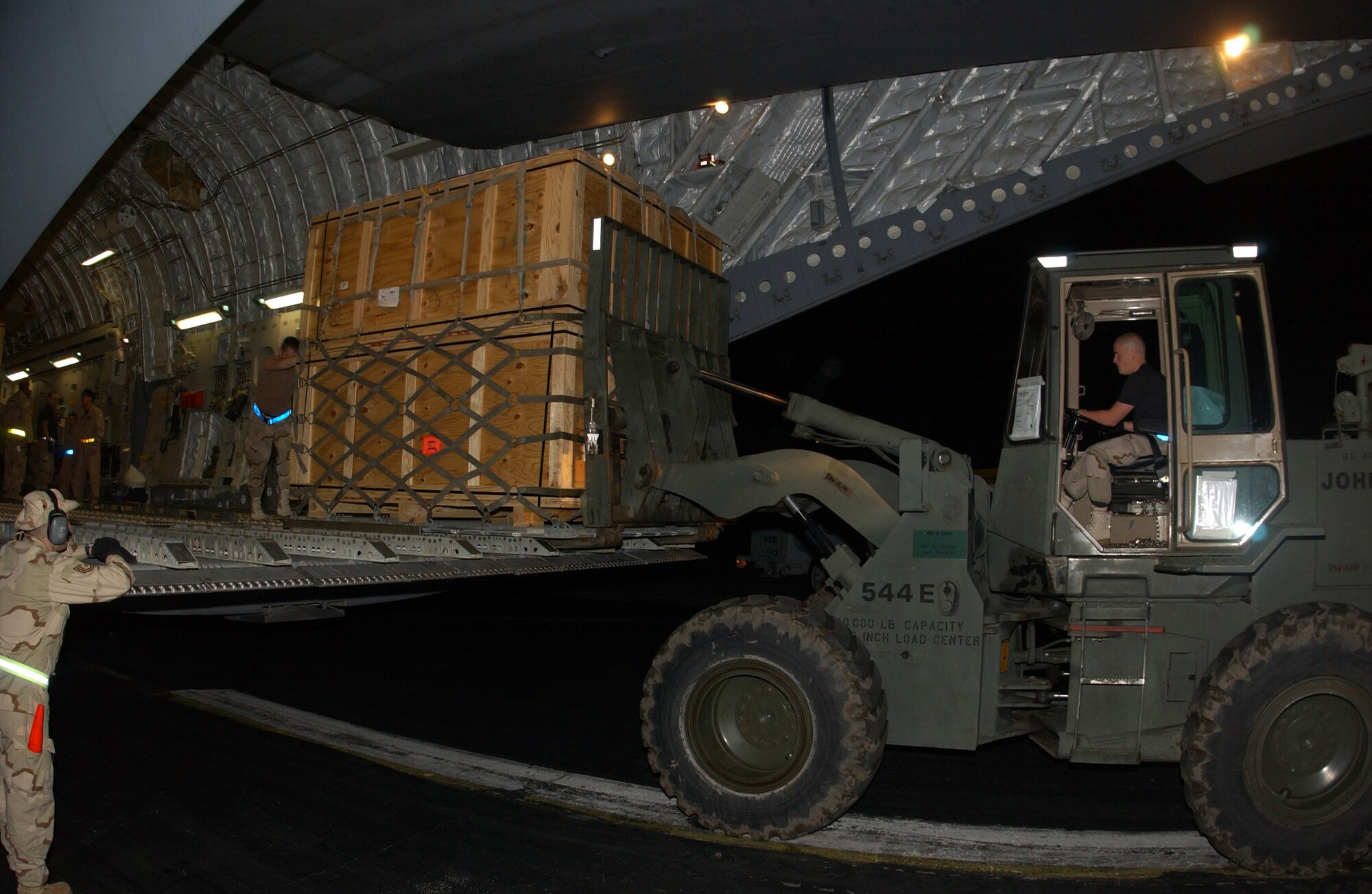 Islamabad, Pakistan --  Airman unload cargo here as part of the Pakistan earthquake relief effort. The earthquake has killed an estimated 40,000 people and has left thousands more injured in Afganistan, Pakistan, India and the Kashmir region. (U.S. Air Force photo by Airman 1st Class De-Juan Haley)