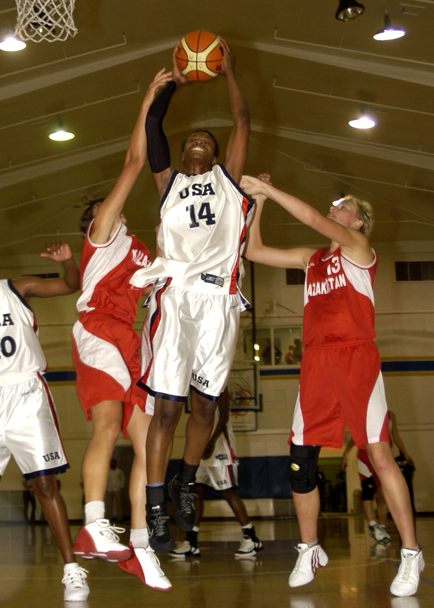 NAVAL BASE VENTURA COUNTY, Calif. -- Airman 1st Class Naomi Mobley, 6-foot-3-inch power forward {14} takes a rebound away from two Kazakhstan players. A player with the U.S. Armed Forces Team, she helped her team win the gold medal at the Conseil International du Sport Militaire World Women's Basketball Championship here. The Airman was the 2005 All-Armed Forces Most Valuable Player. Airman Mobley is a vehicle operator in the 354th Logistics Readiness Squadron, Eielson Air Force Base, Alaska. (U.S. Navy photo)