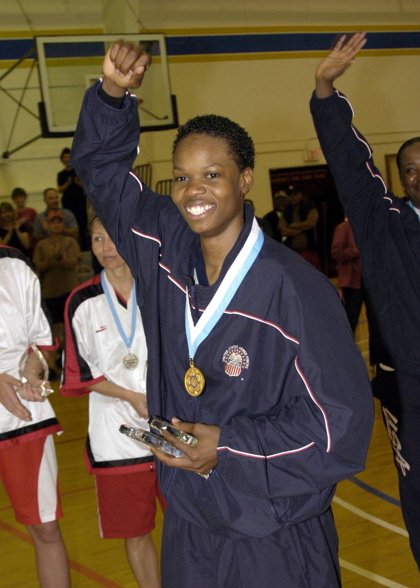 NAVAL BASE VENTURA COUNTY, Calif. -- Airman 1st Class Naomi Mobley, 6-foot-3-inch power forward for the U.S. Armed Forces Women's Basketball Team, receives a gold medal after the Conseil International du Sport Militaire World Women's Basketball Championship here. Airman Mobley is a vehicle operator in the 354th Logistics Readiness Squadron at Eielson Air Force Base, Alaska. (U.S. Navy photo)