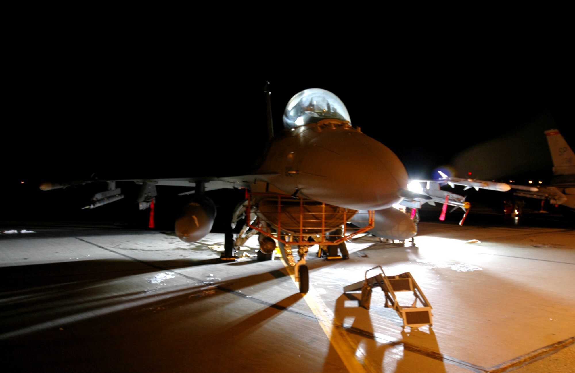 EIELSON AIR FORCE BASE, Alaska -- Done for the night, an F-16 Fighting Falcon from the 22nd Fighter Squadron, Spangdahlem Air Base, Germany, sits on the flightline here. Spangdahlem Airmen are part of the 1,000 active duty and Air National Guard Airmen and 87 aircraft taking part in exercise Cope Thunder 06-1, which ends Oct. 21. Pacific Air Forces hosts the two-week air combat training exercise. (U.S. Air Force photo by Airman 1st Class Justin Weaver)
