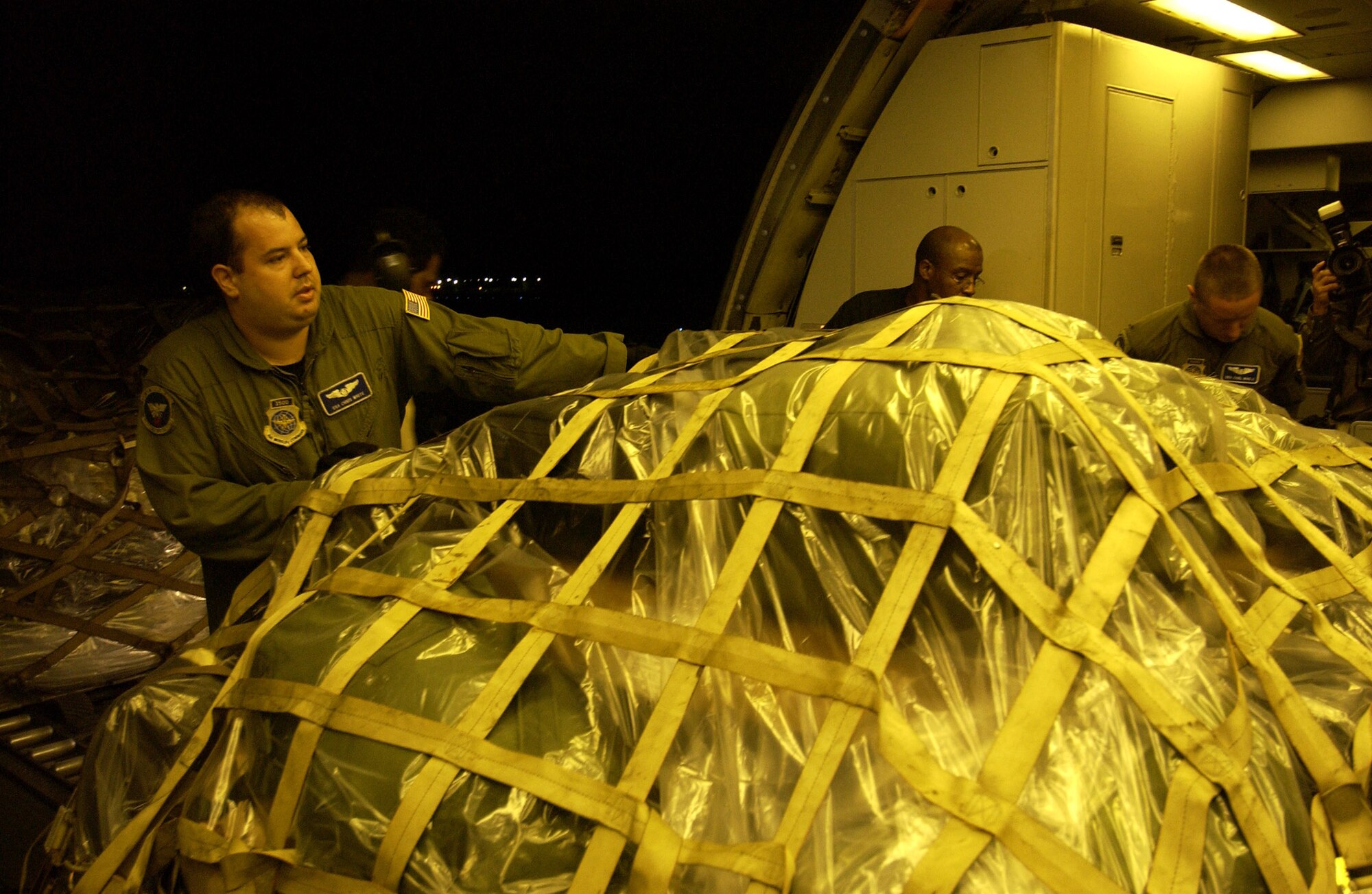 LANGLEY AIR FORCE BASE, Va. -- An Airman loads a KC-10 Extender with relief supplies here Oct. 11.  The Air Force is delivering disaster relief supplies and services as part of a multinational effort to provide aid and support to Pakistan and parts of India and Afghanistan following a devastating earthquake.  The KC-10 is from McGuire Air Force Base, N.J.  (U.S. Air Force photo by Tech. Sgt. Mike Buytas)