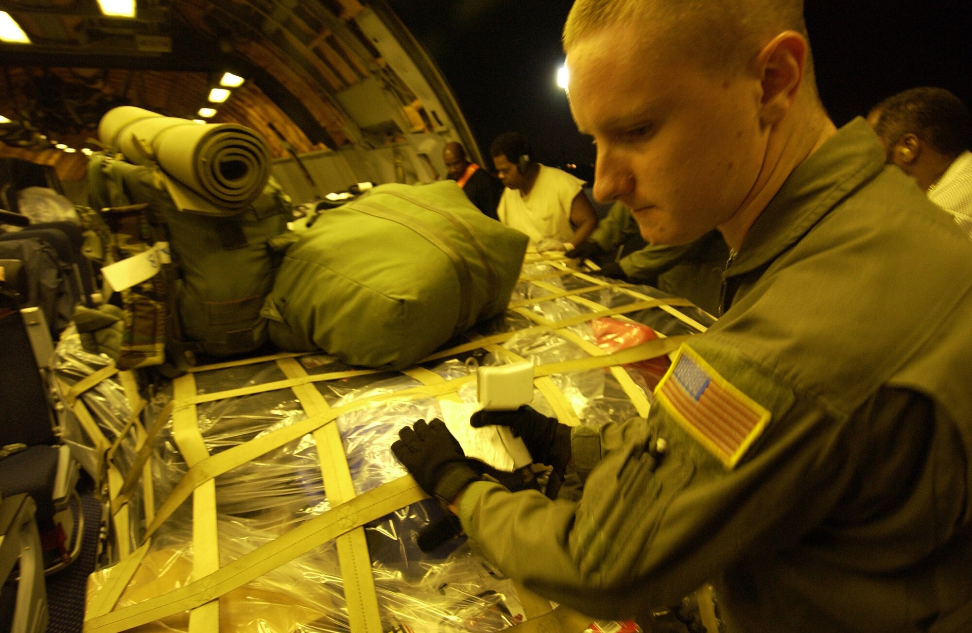 LANGLEY AIR FORCE BASE, Va. -- An Airman loads a KC-10 Extender with relief supplies here Oct. 11.  The Air Force is delivering disaster relief supplies and services as part of a multinational effort to provide aid and support to Pakistan and parts of India and Afghanistan following a devastating earthquake.  The KC-10 is from McGuire Air Force Base, N.J.  (U.S. Air Force photo by Tech. Sgt. Mike Buytas)