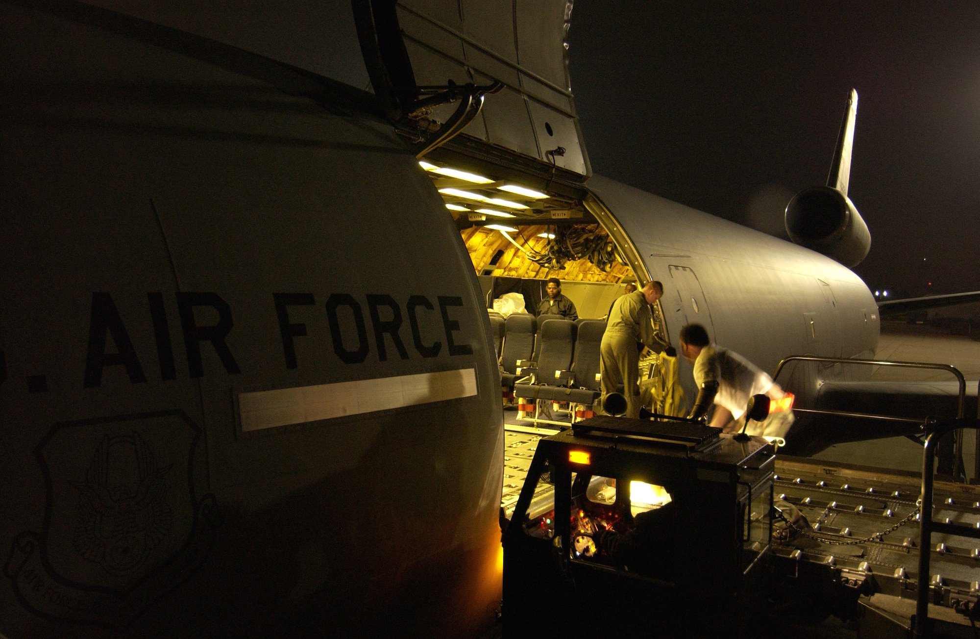 LANGLEY AIR FORCE BASE, Va. -- Airmen load a KC-10 Extender aircraft with relief supplies here Oct. 11.  The Air Force is delivering disaster relief supplies and services as part of a multinational effort to provide aid and support to Pakistan and parts of India and Afghanistan following a devastating earthquake.  The KC-10 is from McGuire Air Force Base, N.J.  (U.S. Air Force photo by Tech. Sgt. Mike Buytas)