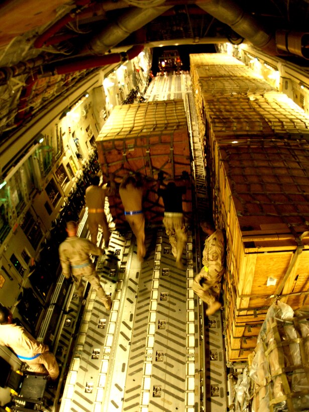 ISLAMABAD, Pakistan -- Airmen unload cargo from a C-17 Globemaster III here Oct. 11. The aircraft, from the 379th Air Expeditionary Wing at McChord Air Force Base, Wash., flew in approximately 50 tons of food and shelter equipment as part of the Pakistan earthquake relief effort. The earthquake has killed an estimated 40,000 people and has left thousands more injured in Afghanistan, Pakistan, India and the Kashmir region. (U.S. Air Force photo by Airman 1st Class De-Juan Haley)