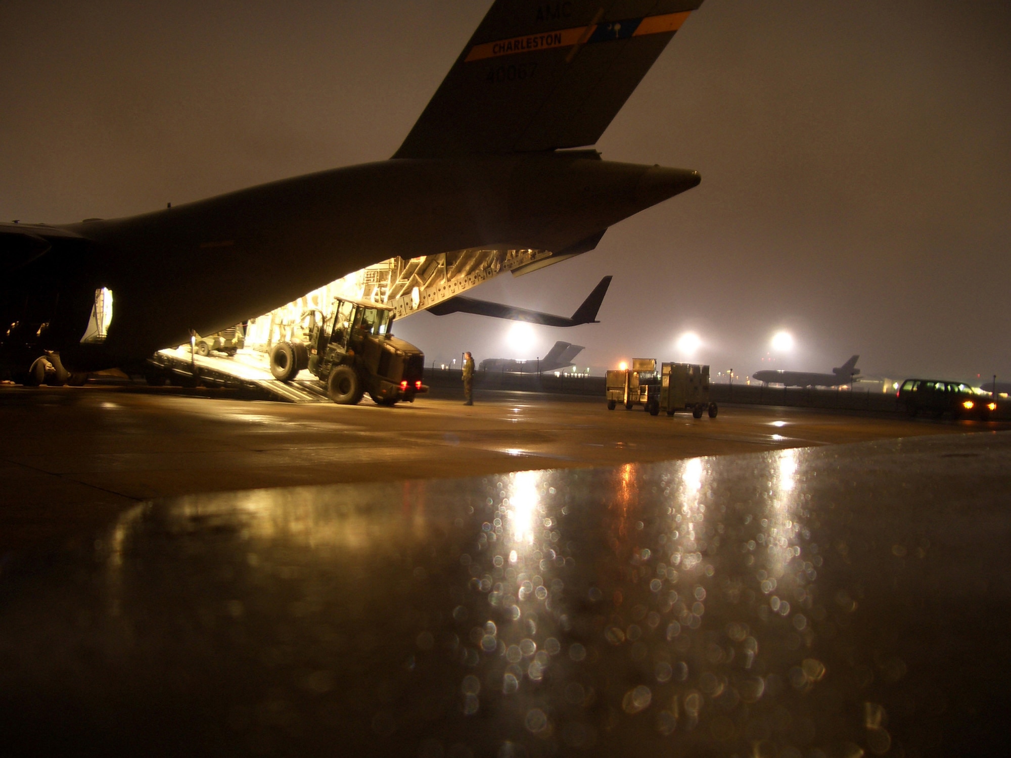 MCGUIRE AIR FORCE BASE, N.J. -- Members of the 305th Aerial Port Squadron load a C-17 Globemaster III here. The aircraft, loaded with relief supplies and members of the 621st Contingency Response Wing, left here Oct. 10, bound for Pakistan to support earthquake relief operations. Both Airmen are assigned to the 305th Aerial Port Squadron here. (U.S. Air Force photo by Senior Airman Dilia DeGrego)