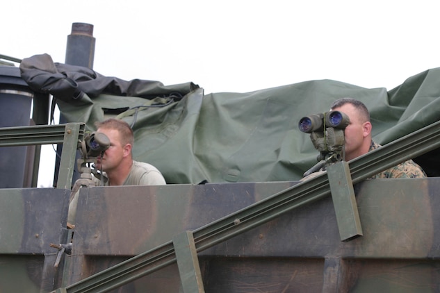 Observers look over the field at the students in the Scout Sniper Basic Course as the students stalk them and try to take a shot within 400 meters, Oct. 13, at Schofield Barracks East Range Training Area. If a Marine is spotted by an observer he is called out and must leave the field.