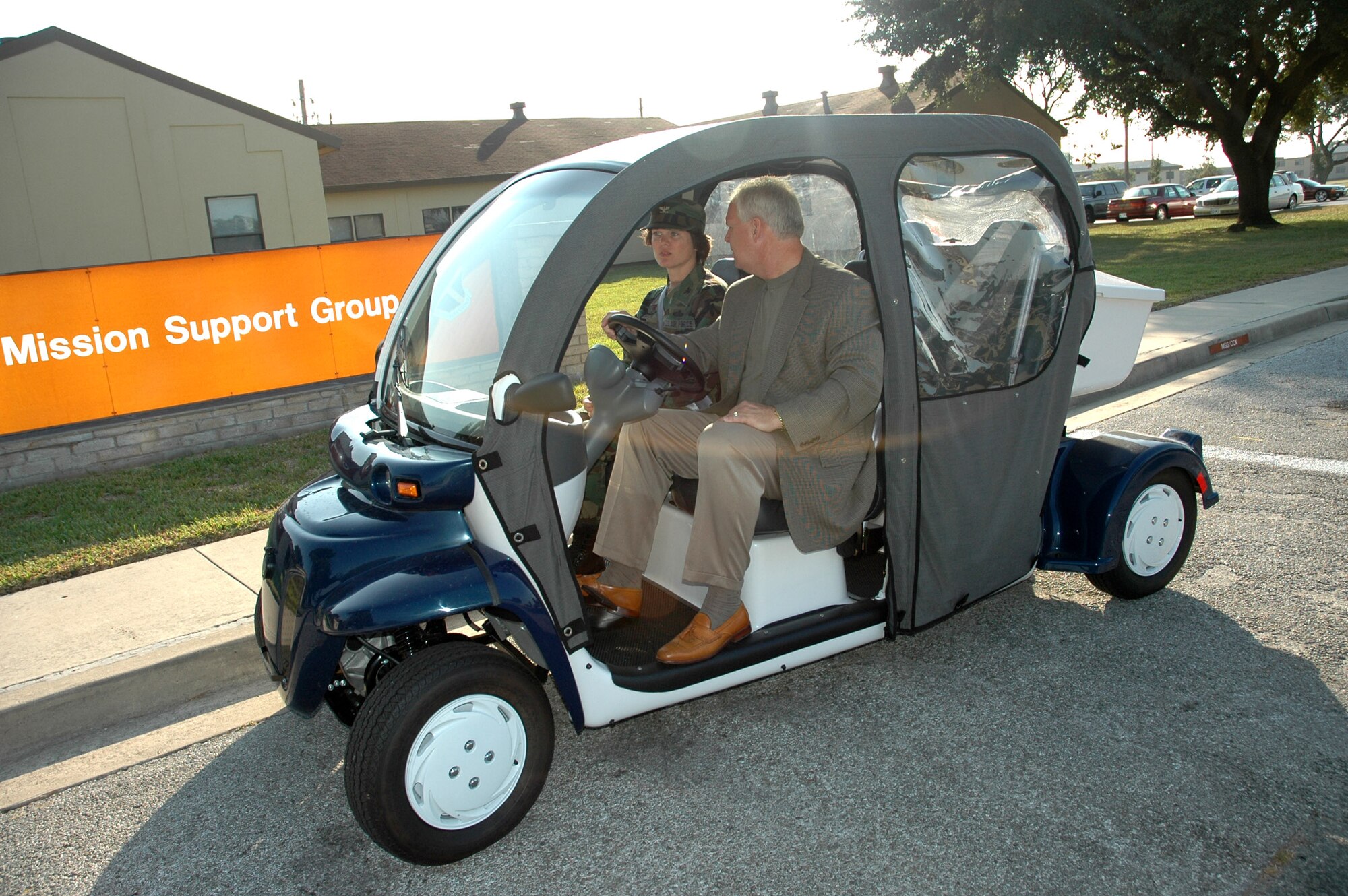LACKLAND AIR FORCE BASE, Texas -- Col. Thelma Hales (left) and George DeCoux test one of the new Global Electric Motorcars this base is using to conserve energy. The GEM seats four people and can travel at 25 mph. The colonel is commander of the 37th Mission Support Group at this training base. Mr. DeCoux is the unit's deputy for installations. (U.S. Air Force photo by Raymond V. Whelan) 