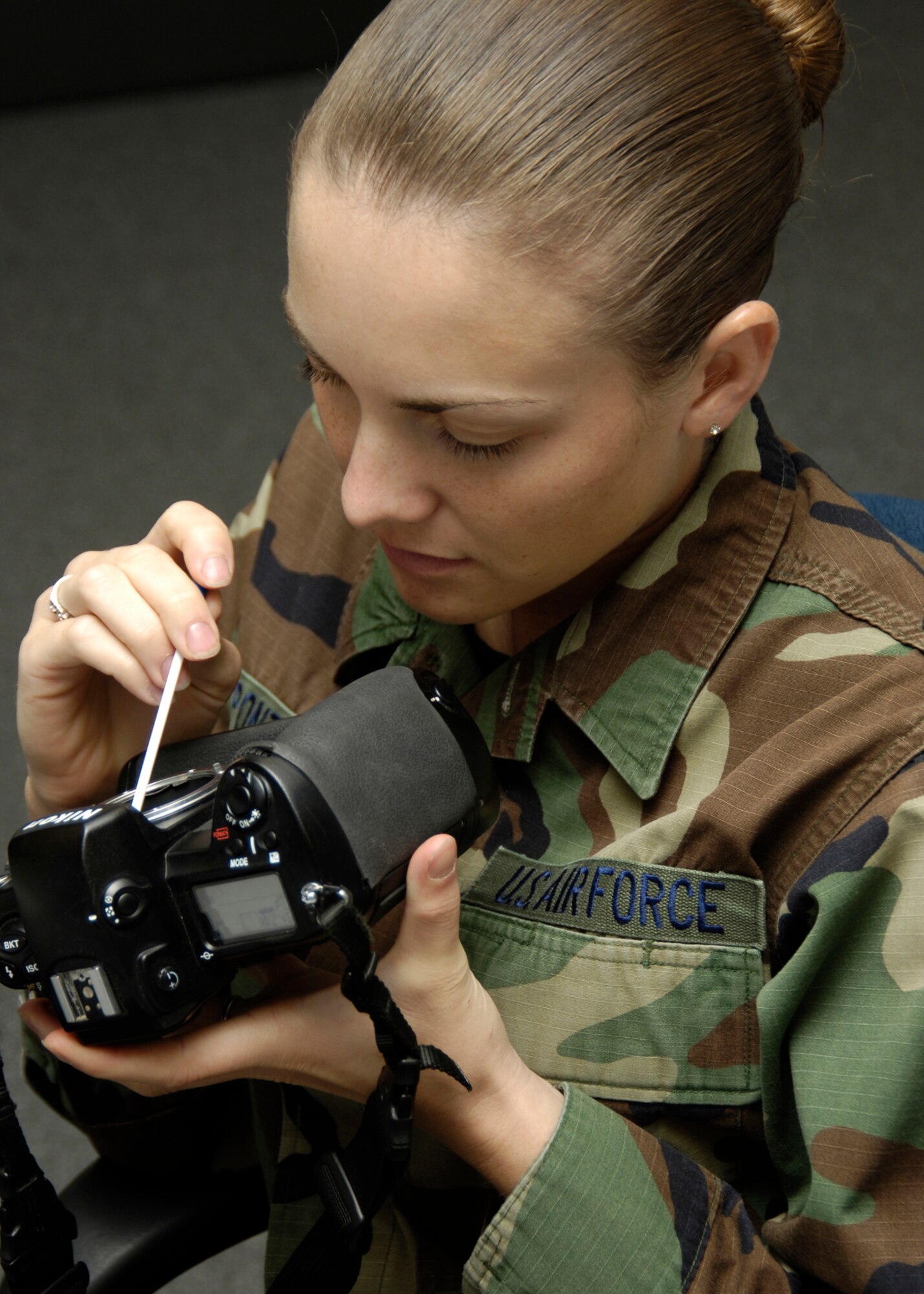 DAVIS-MONTHAN AIR FORCE BASE, Ariz. -- Airman 1st Class Christina Ponte, a still photographer with the 355th Communications squadron here, checks her Nikon D1X camera. She did her function check before going on an assignment Oct. 13. (U.S. Air Force photo by Airman 1st Class Jesse Shipps)