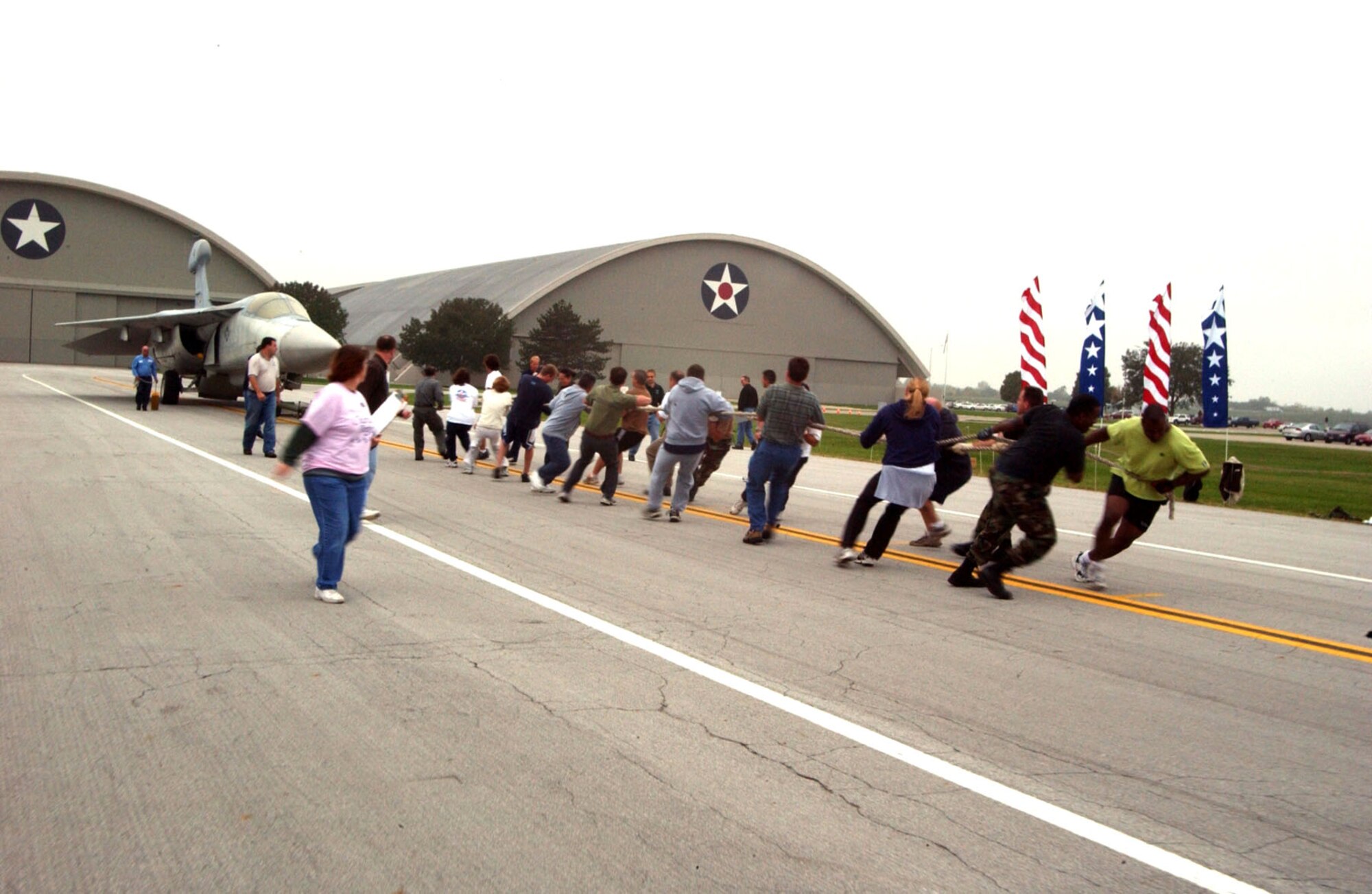 DAYTON, Ohio -- Aircraft pull participants strain against an EF-111A Raven aircraft during the seventh annual Combined Federal Campaign Aircraft Pull at the National Museum of the United States Air Force here. (U.S. Air Force photo by Jeff Fisher)
