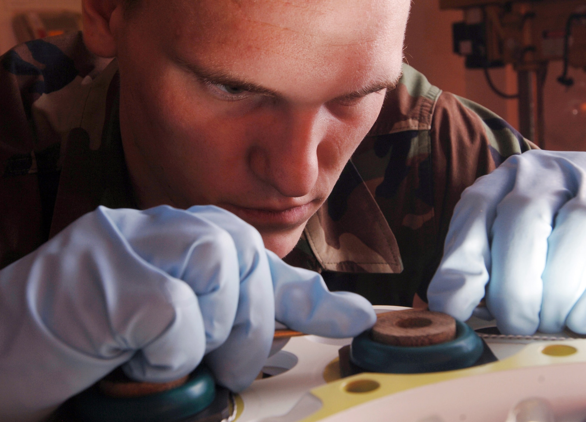 YOKOTA AIR BASE, Japan -- Airman 1st Class Daniel Arrington inserts pistons on a C-130 Hercules brake assembly carrier at his facility here. A pneudraulics element troop with the 374th Maintenance Squadron, he overhauls, modifies and tests all pneudraulics components on the C-130s assigned here and those that land here in transit. (U.S. Air Force photo by Master Sgt. Val Gempis)
