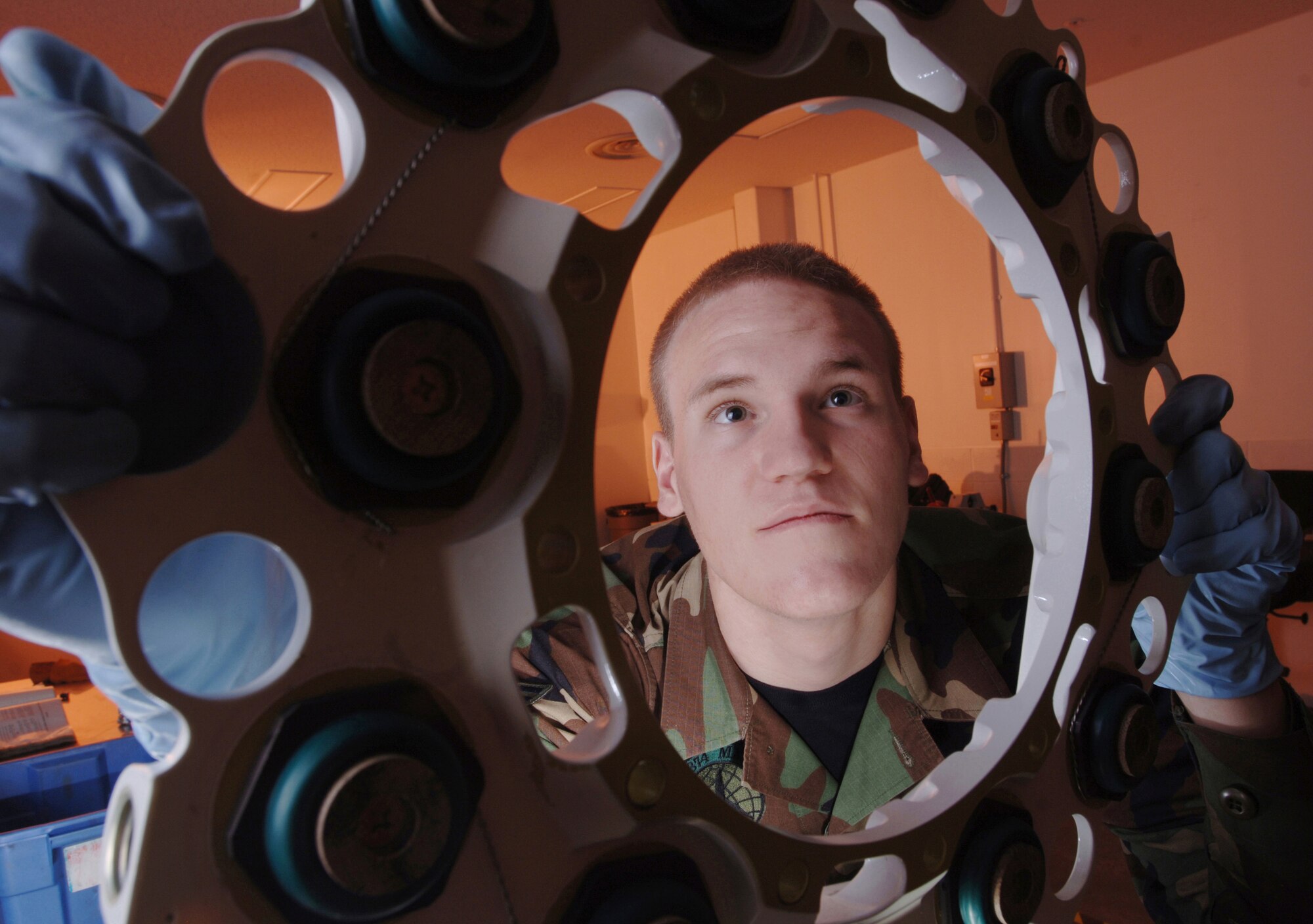 YOKOTA AIR BASE, Japan -- Airman 1st Class Daniel Arrington checks a C-130 Hercules brake assembly carrier at his facility here. The pneudraulics element troop with the 374th Maintenance Squadron, the Airman overhauls, modifies and tests all pneudraulics components on the C-130s assigned here and those that land here in transit. (U.S. Air Force photo by Master Sgt. Val Gempis)