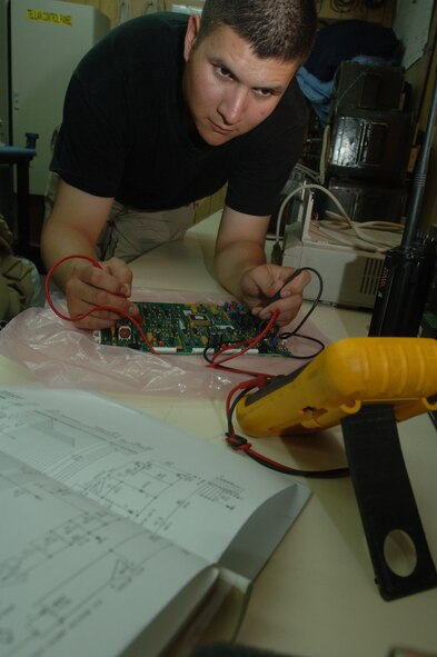 ALI AIR BASE, Iraq -- Airman 1st Class Class Sergio Santos troubleshoots the base "giant voice" circuit card to isolate bad components. The communications system ensures the base has a reliable warning signal for the safety of base members. The Airman, a radio ground maintenance troop with the 407th Expeditionary Communications Squadron, did his check Oct. 13. He is deployed here from the 52nd Communications Squadron at Spangdahlem Air Base, Germany. (U.S. Air Force photo by Senior Airman Jennifer Haas)