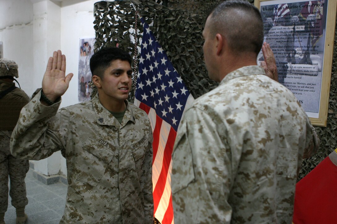 CAMP TAQADDUM, Iraq (Oct. 16, 2005) – Sergeant Ashley J. Zoza, an air traffic control communications technician with Marine Air Control Squadron 2, 2nd Marine Aircraft Wing, raises his right hand and pledges to support and defend the constitution of the United States of America before Brigadier Gen. John E. Wissler, commanding general, 2nd Force Service Support Group (Forward), in a ceremony here Oct. 15. Zoza, a Van Buren, Ark., native, deployed to Iraq in July as part of Operation Iraqi Freedom. (Photo by Cpl. John E. Lawson Jr.)