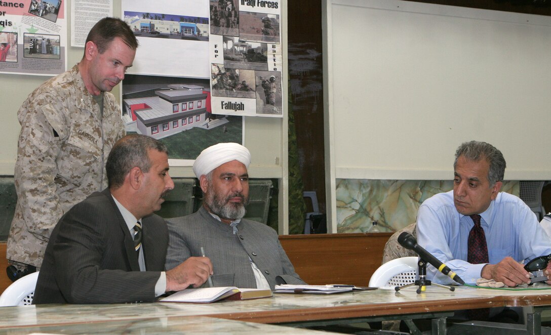 FALLUJAH, Iraq (Oct. 15, 2005) -- Sheikh Dhari Al-Zobaie, mayor of Fallujah, speaks to Ambassador Zalmay Khalilzad, U.S. Ambassador to Iraq, while the Sheikh Kamal, chairman of the Fallujah City Council and Lt. Col. Patrick Carroll listen during a meeting held here Oct. 15. The meeting marked Khalilzad's first visit to Fallujah.