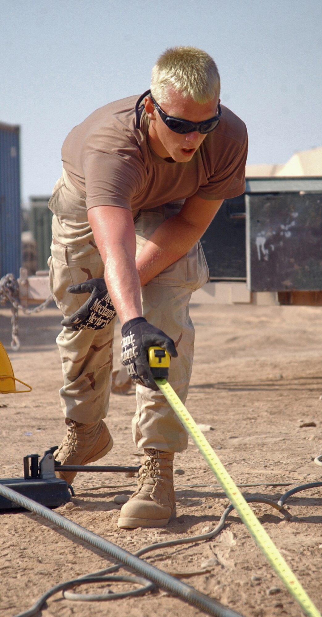 BALAD AIR BASE, Iraq -- Airman Michael Keller measures a piece of rebar before cutting. The rebar will be used to help support the cement foundation for a new communications tower. The Airman is part of the 332nd Expeditionary Civil Engineering Squadron here. (U.S. Air Force photo by Staff Sgt. Tammie Moore)                                    