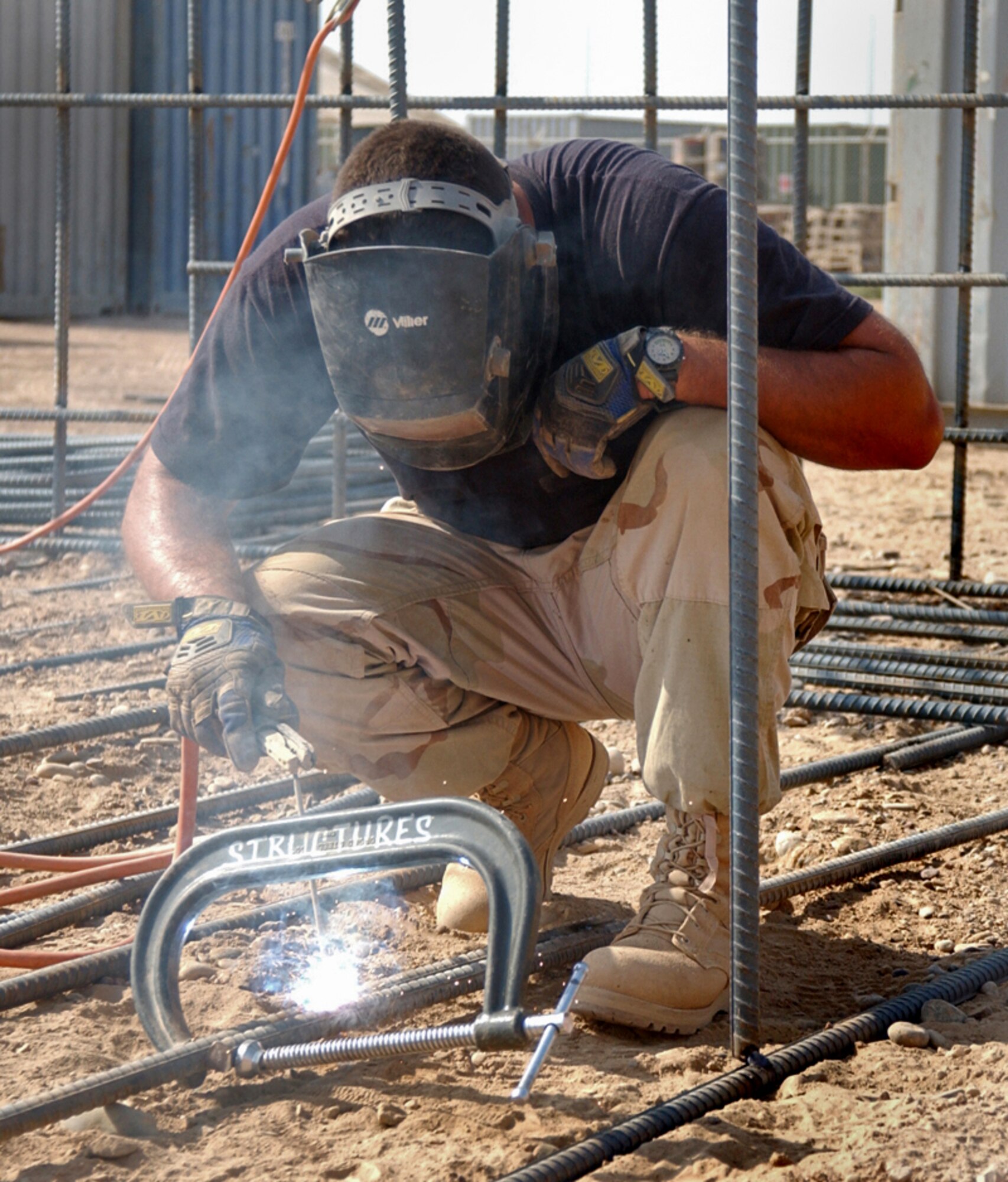 BALAD AIR BASE, Iraq -- Staff Sgt. Lance Lewis welds rebar together that will be used for a concrete foundation for a communications tower. The sergeant is part of the 332nd Expeditionary Civil Engineering Squadron here. (U.S. Air Force photo by Staff Sgt. Tammie Moore)