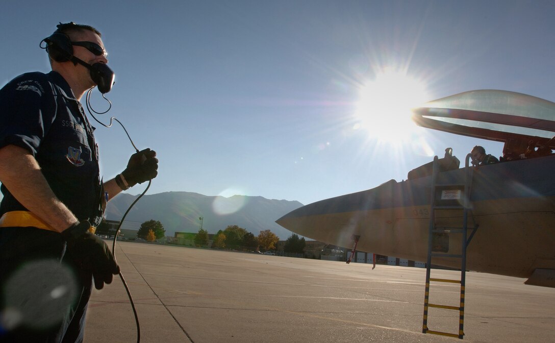 HILL AIR FORCE BASE, Utah -- Staff Sgts. John Barr (left) and James Gainville (cockpit), do a preflight inspection on an F/A-22 Raptor here. The 27th Fighter Squadron dedicated crew chiefs, from Langley Air Force Base, Va., did the check Oct. 16. The unit deployed here to put the first operational F/A-22 Raptor squadron through the paces in a deployment environment, including live bomb training. (U.S. Air Force photo by Staff Sgt. Samuel Rogers)