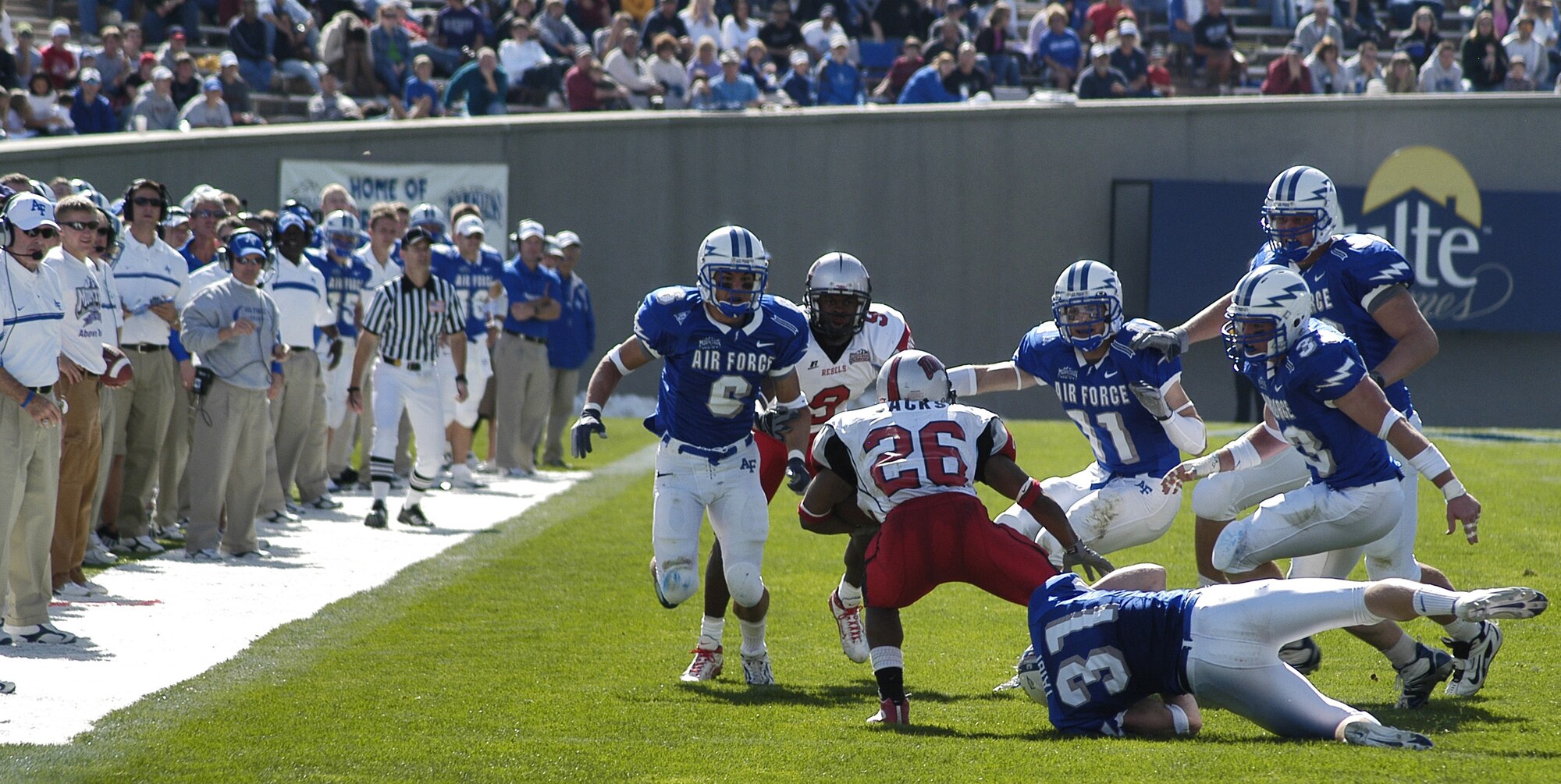 U.S. AIR FORCE ACADEMY, Colo. -- Falcon defensive back John Taibi grabs UNLV running back Erick Jackson, as a host of Air Force defenders zero in. (U.S. Air Force photo by 2nd Lt. John Ross) 
