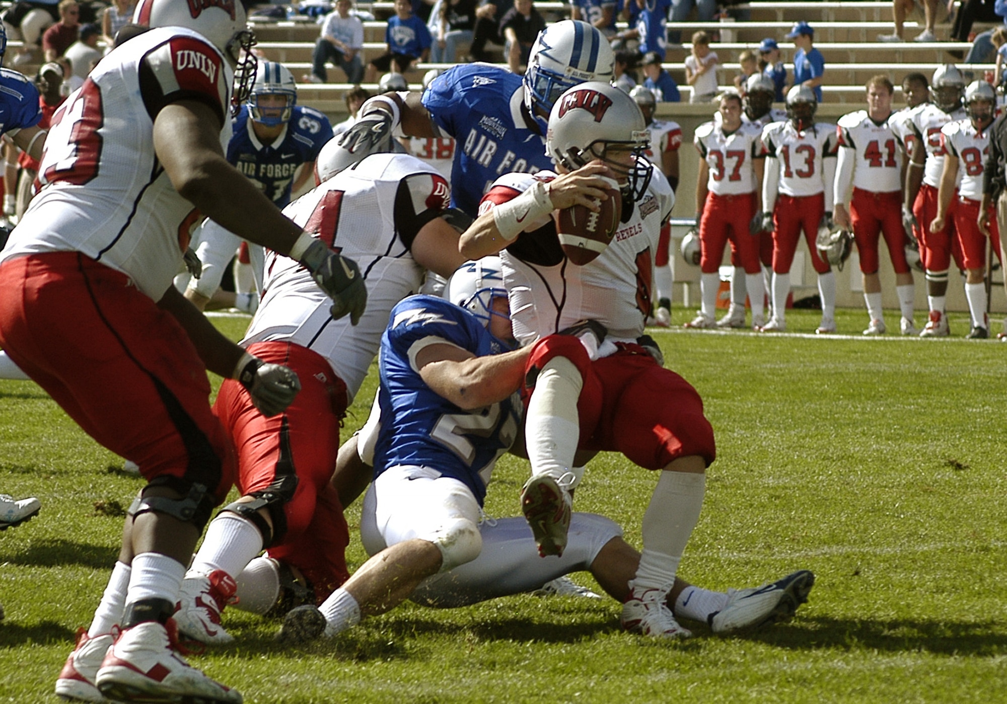 U.S. AIR FORCE ACADEMY, Colo. -- Falcon defensive back Denny Poland, 27, pulls down UNLV quarterback Jarrod Jackson for one of Air Force's five sacks. (U.S. Air Force photo by 2nd Lt. John Ross) 
