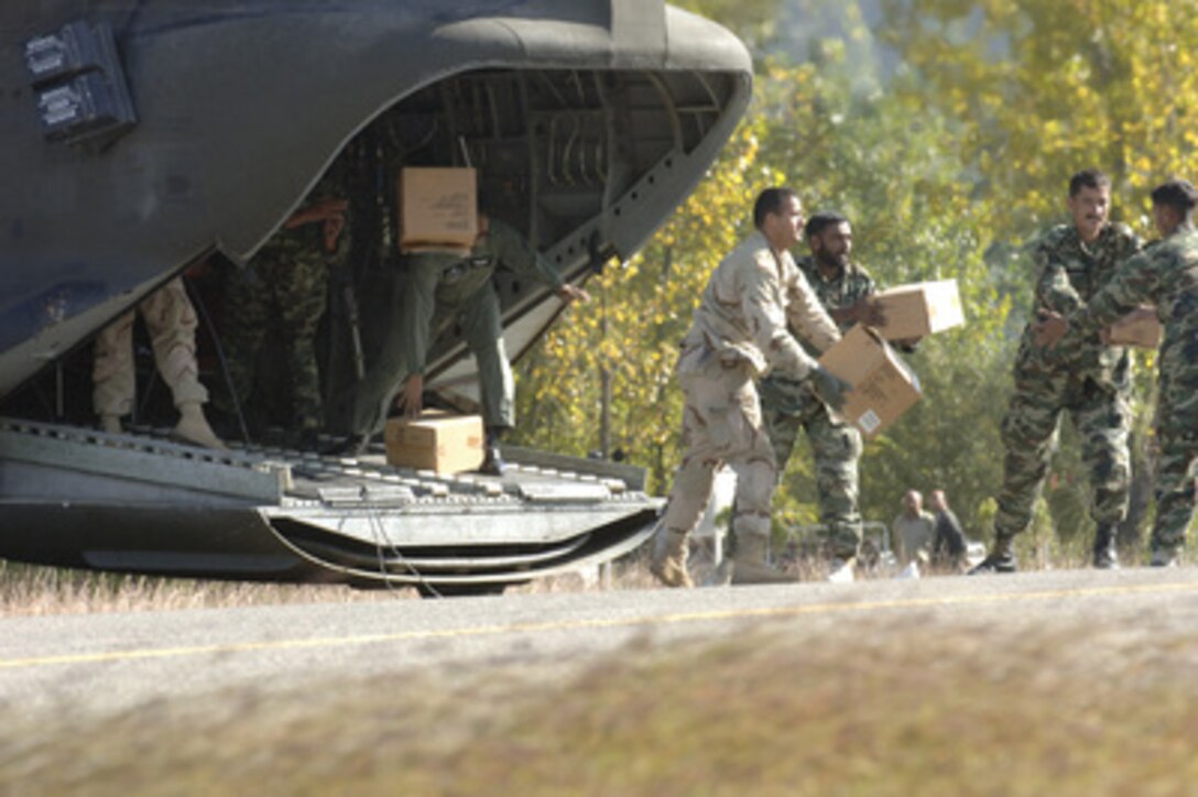U.S. Army Cpl. Amit Ranadey assists in unloading relief supplies from a U.S. Army CH-47 Chinook helicopter in the village of Rawala Kot, Pakistan, on Oct. 14, 2005. The Department of Defense is participating in the multinational effort to provide humanitarian assistance and support to Pakistan and parts of India and Afghanistan following a devastating earthquake. 