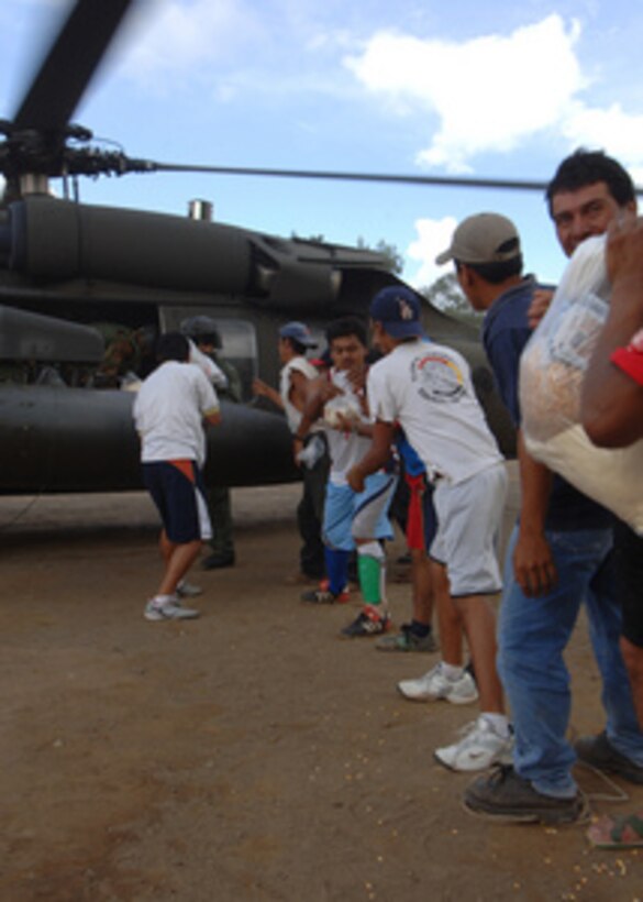 Victims of Hurricane Stan in Guatemala form long lines helping to move food, water, and medicine from a US. Army Black Hawk helicopter, on Oct 15, 2005. U.S. military personnel with the U.S. Southern Command Joint Task Force Bravo continue to provide assistance to the government and the people of Guatemala as part of an ongoing disaster relief effort in the wake of Hurricane Stan. 