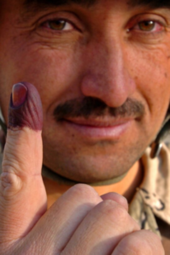 An Iraqi solider proudly displays his ink stained finger after voting in the country's national referendum on the draft constitution in Tal Afar, Iraq, on Oct. 15, 2005. Iraqi Army security forces with assistance from the 3rd Armored Cavalry Regiment and 82nd Airborne Unit are providing security for the region of Tal Afar in order to disrupt terrorists from derailing the election process. 