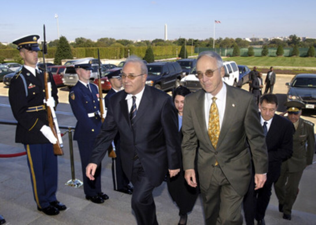 Acting Deputy Secretary of Defense Gordon England (right) escorts Bulgarian Minister of Defense Vesselin Bliznakov (left) through an honor cordon and into the Pentagon on Oct. 17, 2005. England and Bliznakov will meet to discuss security issues of interest to both nations. 