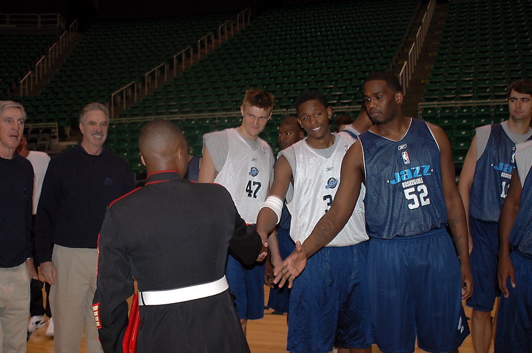 Gunnery Sergeant Miguel Bridges, Recruiting Station Salt Lake City, is congratulated by players and coaches of the Utah Jazz after re-enlisting at the Delta Center, Oct. 17.
