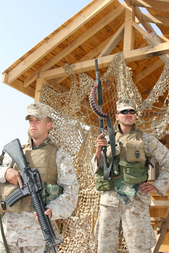 Cpl. Adam Throne, a field artillery cannoneer and Mason City, Iowa, native, and Lance Cpl. Lance Clark, a field artillery cannoneer and Des Moines, Iowa, native, stand post at a remote detention facility, Oct. 18, at Al Asad, Iraq. The Detention Company Marines and Sailors from 5th Battalion, 14th Marine Regiment, serve as lock and key holders for detainees at the RDF.