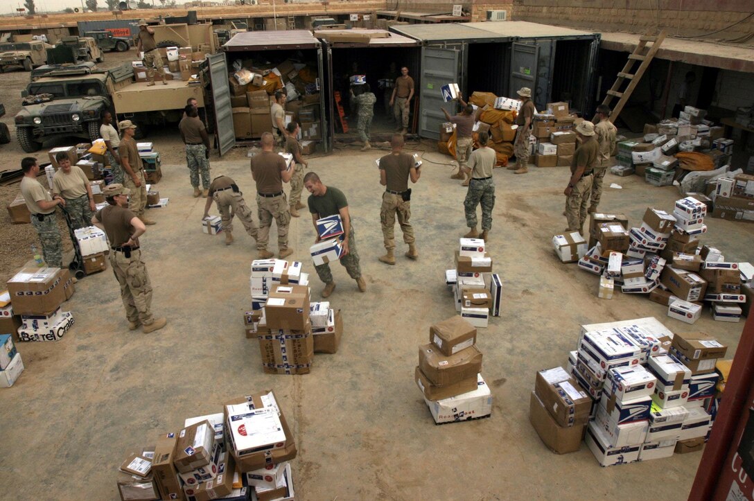 Marines and soldiers work to unload a shipment of mail destined for service members based throughout Ramadi.