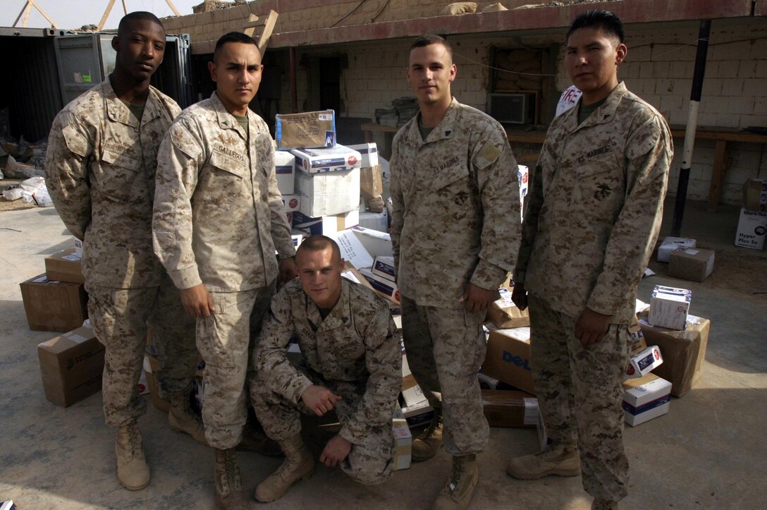 (From left) Private first class Brandon A. Hill, Lance Cpl. Carlos L. Gallegos, Sgt. Addam C. Baker, Cpl. Daniel E. Webster and Lance Cpl. Harlan C. Roundstone are in charge of ensuring mail destined for service members throughout Ramadi reaches its intended recipients.