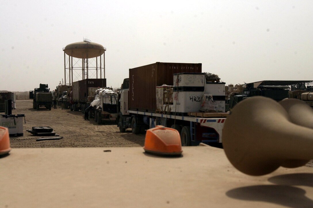 A convoy bringing supplies to units here pulls in to an offload area.