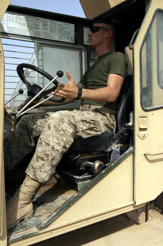 Cpl. Andrew Breen, a 21-year-old Oracle, Ariz. native and heavy equipment operator assigned to Task Force Roadrunner works inside the cab of a high-speed high-mobility crane.