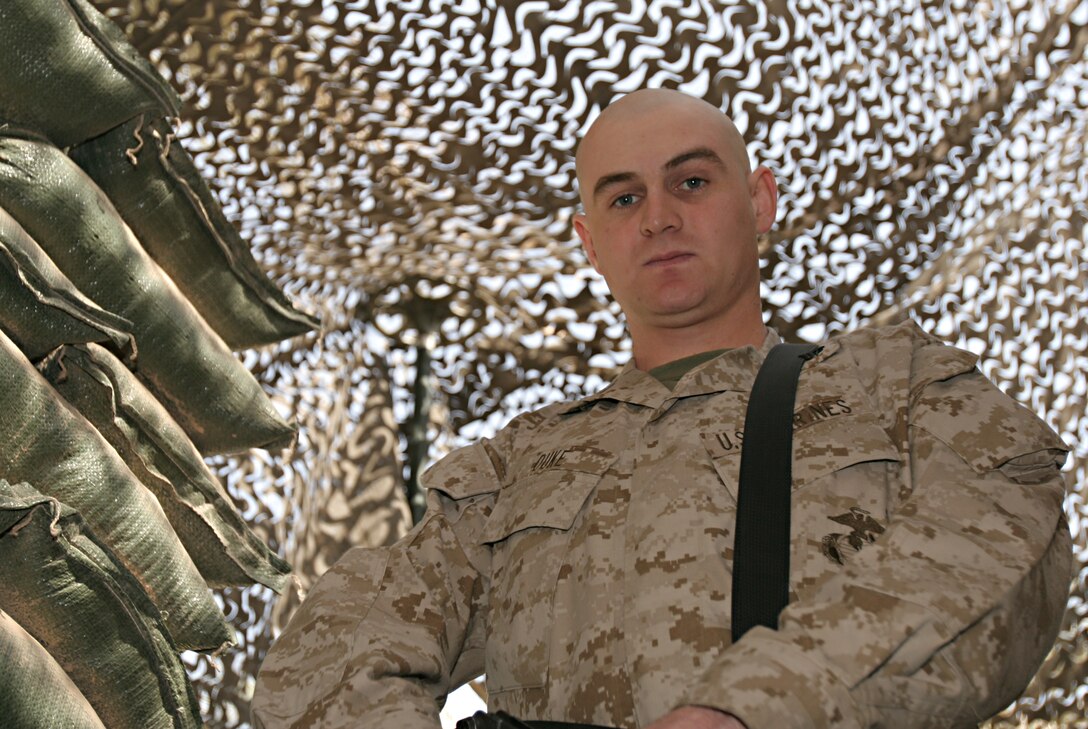 Corporal Leonard B. Huebner (left), a 21-year-old native of Buchanan, Mich., and motor transportation mechanic and Spc. Sandra S. Cardenas, a 25-year-old native of Exeter, Penn., and finance specialist help unload a shipment of mail destined for service members based throughout Ramadi.