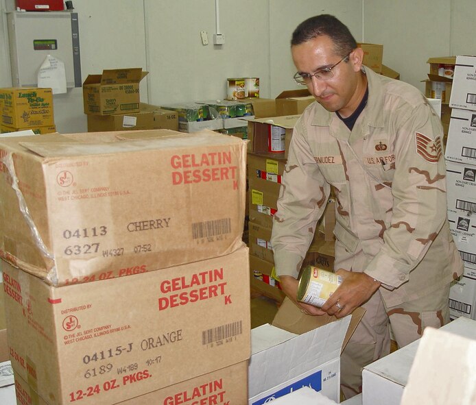 SOUTHWEST ASIA -- Tech. Sgt. Jeimmy Bermudez unpacks food boxes in a store room here. Sergeant Bermudez orders food shipments, unloads and stocks supplies. He is assigned to the 380th Expeditionary Services Squadron. (U.S. Air Force photo by Tech. Sgt. Mike Hammond)