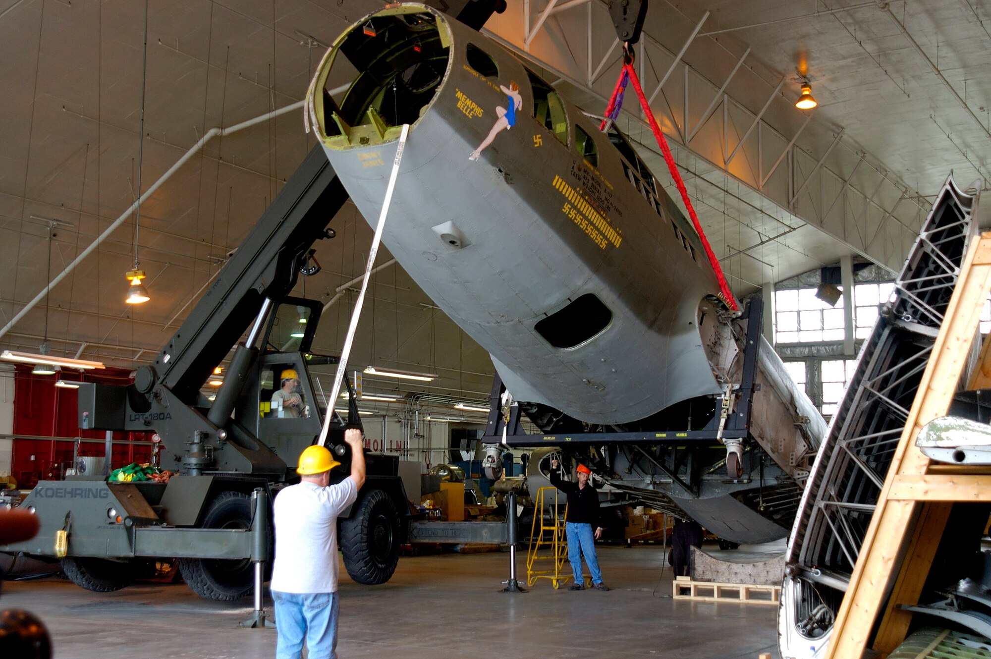 WRIGHT-PATTERSON AIR FORCE BASE, Ohio -- (Left to right), 88th Air Base Wing engineering equipment operator Chris Moon and National Museum of the U.S. Air Force restoration technicians Tim Ward and Greg Hassler unload the fuselage of the B-17F "Memphis Belle" into the museum's restoration hangar.  (U.S. Air Force photo by Jeff Fisher)