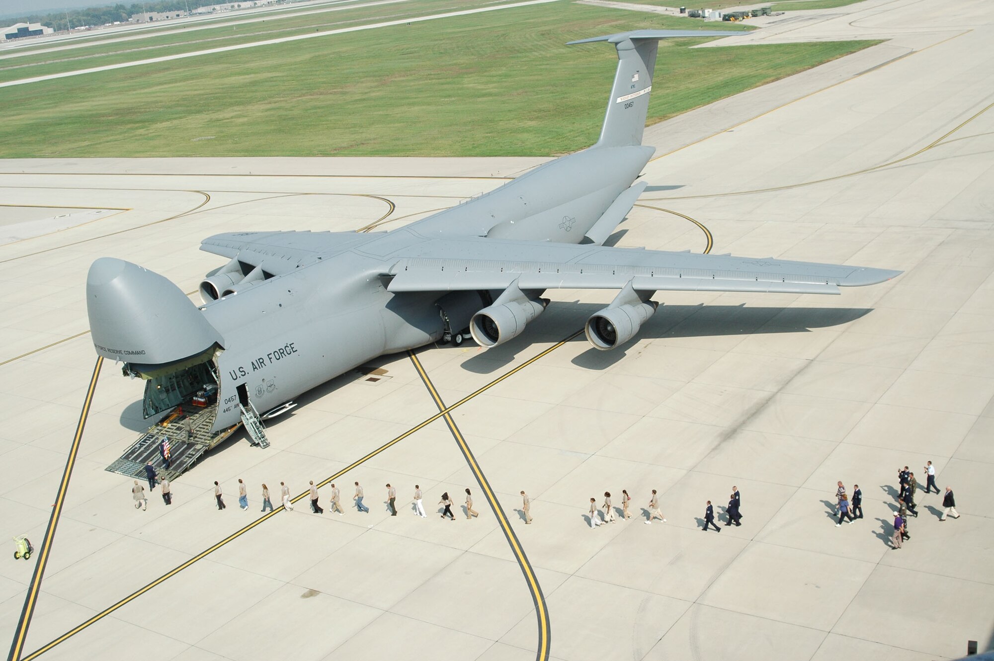 The first of 11 C-5A Galaxy's for the Air Force Reserve Command's 445th Airlift Wing arrived at Wright-Patterson AFB, Ohio, on Oct 3. The C-5s are replacing the C-141 at the unit. Leading the crowd going to view the newly arrived Galaxy are the newest members of the Air Force Reserve Command who took the oath of enlistment in the cargo hauler duing a mass enlistment ceremony.
