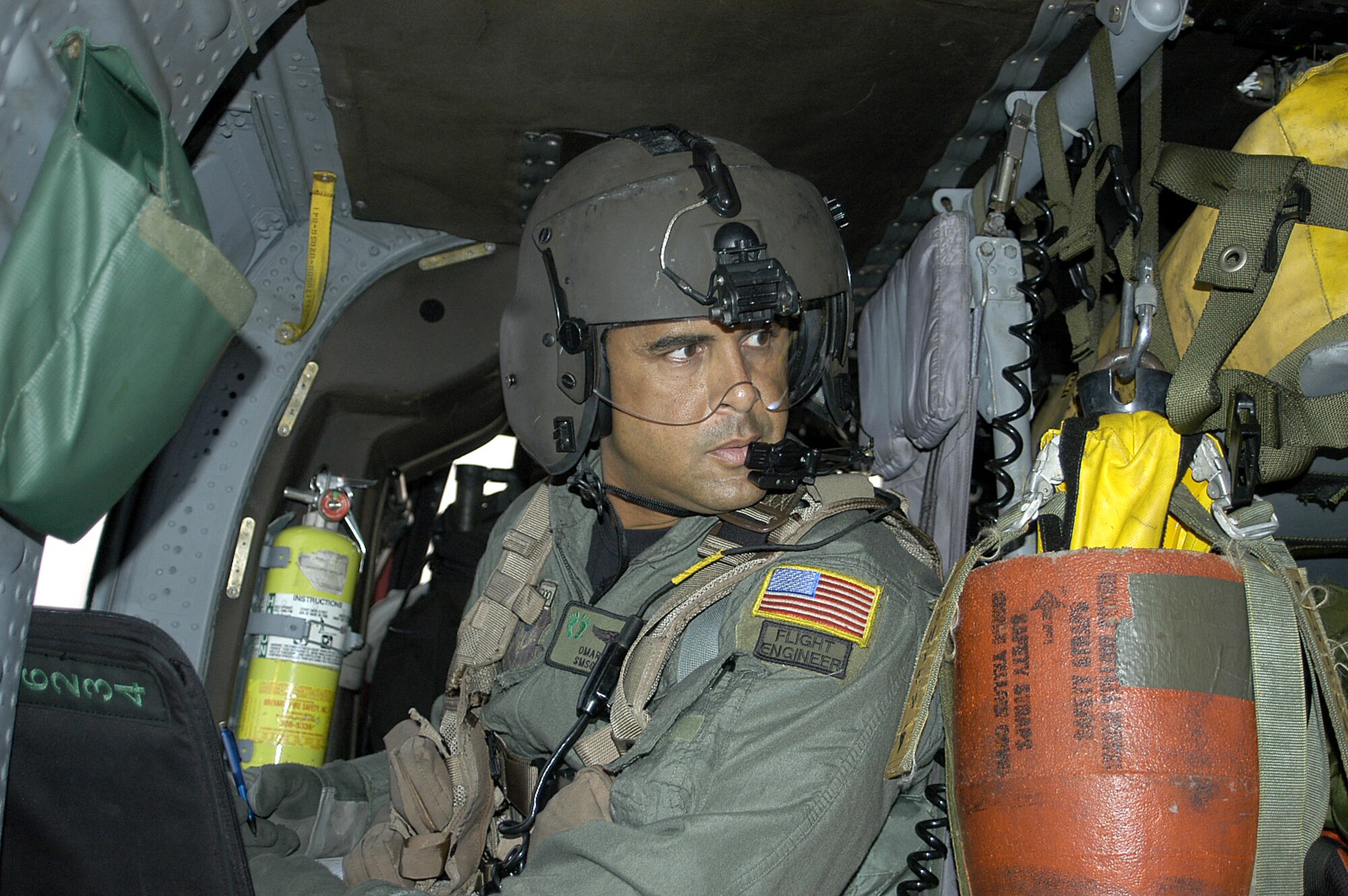 Preparing to take off, Senior Master Sgt. Omar Rivera, an Air Reserve Technician and flight engineer with the 920th Rescue Wing, ensures all systems are go aboard his HH-60 Pave Hawk helicopter Sept. 10.  Working around the clock, Sergeant Rivera and about 100 other reservists supported and flew 6 helicopters saving 472 people in one day. (Air Force photo by Senior Master Sgt. Elaine Mayo)
